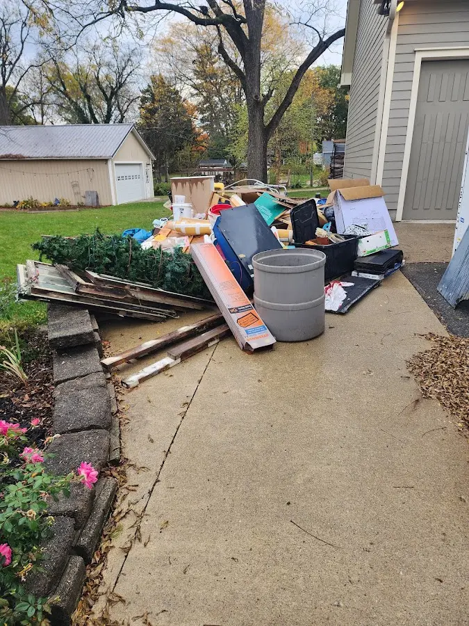 Dumpster being loaded with debris for Roofing Dumpster Rental in Bel Air North